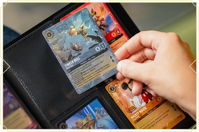 Image of a hand pulling a card from their card collection portfolio