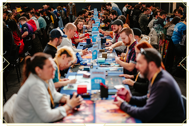 Players at Disney Lorcana Ghent seated at a long table shuffling cards and playing their rounds