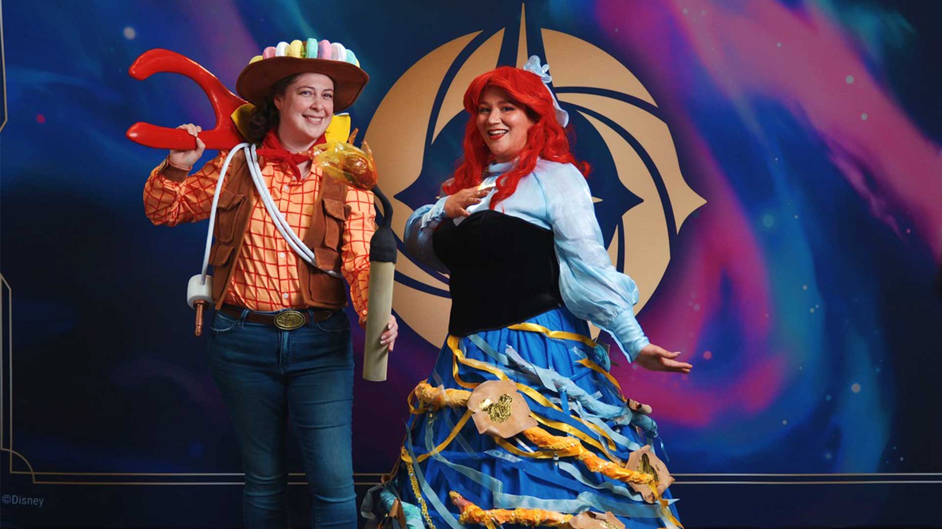 Two women in Disney Lorcana cosplay. One is dressed as Woody from Toy Story. The second is dressed as Arial from Little Mermaid
