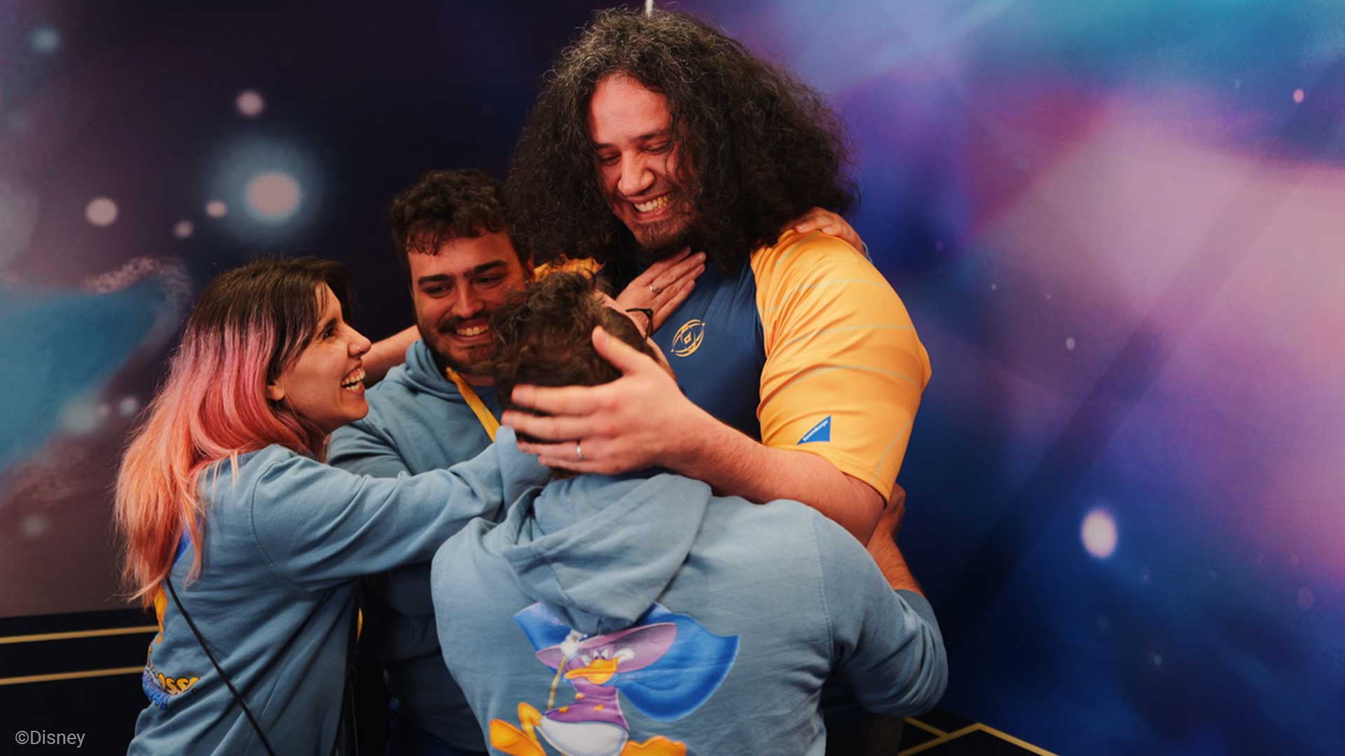Lorcana players hugging each other after an epic win