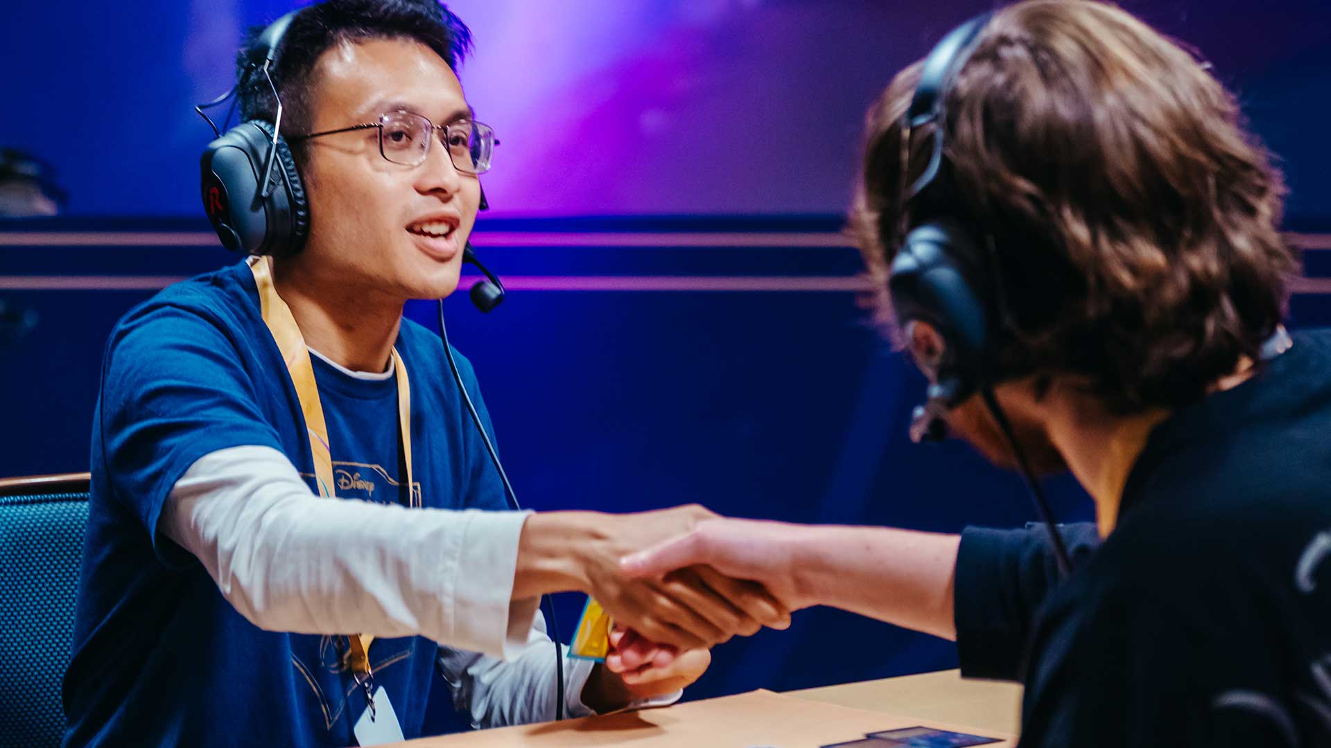 Dillon LeDuc shakes hands with an opponent at the end of the Disney Lorcana Challenge North American Championship
