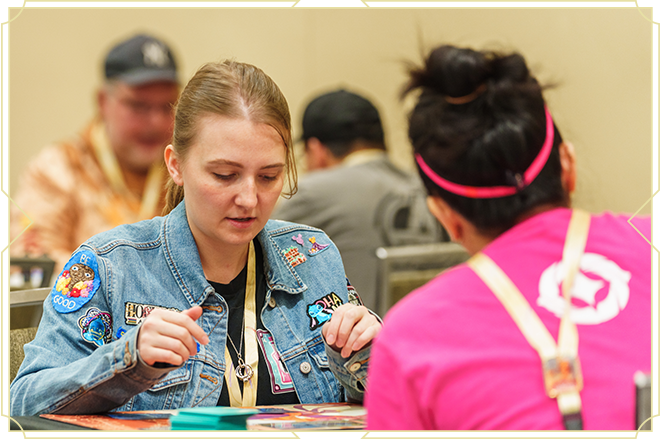 Two people playing Disney Lorcana